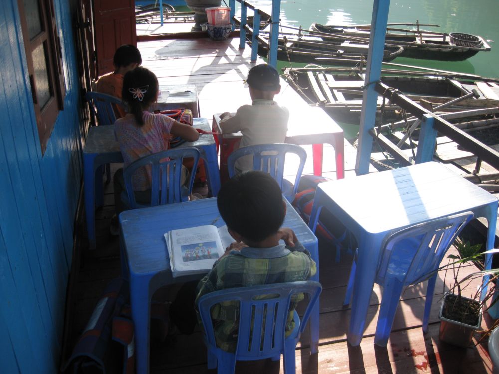 VVV Children Studying on the School Deck by the Water